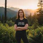 "One Day at a Time" t-shirt, symbolizing strength and hope in addiction recovery. From Wear What You Stand For Products' Addiction Recovery Collection.